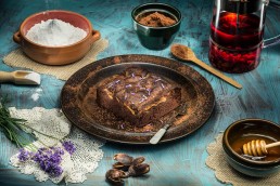 Food photography of chocolate brownie on brown plate and blue board