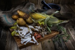 Food Photography, choping board with mushrooms and other root vegetables